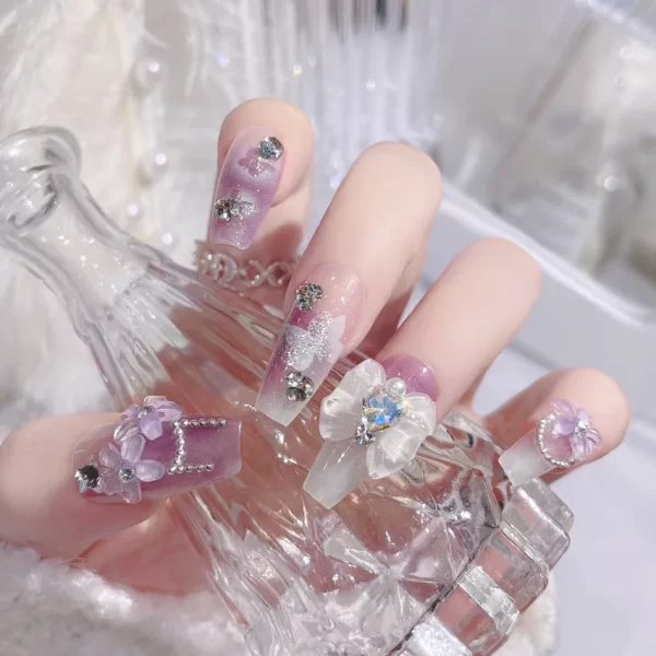 24 pieces of press on nails decorated with butterfly flowers. These luxury acrylic press-on nails are adorned with rhinestones and can be easily removed. They come with glue for easy application.