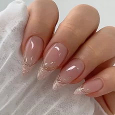 A set of 24 long almond-shaped false nails with a French manicure and a touch of gold on the edges. These press-on nails are perfect for a DIY manicure and can be easily detached.